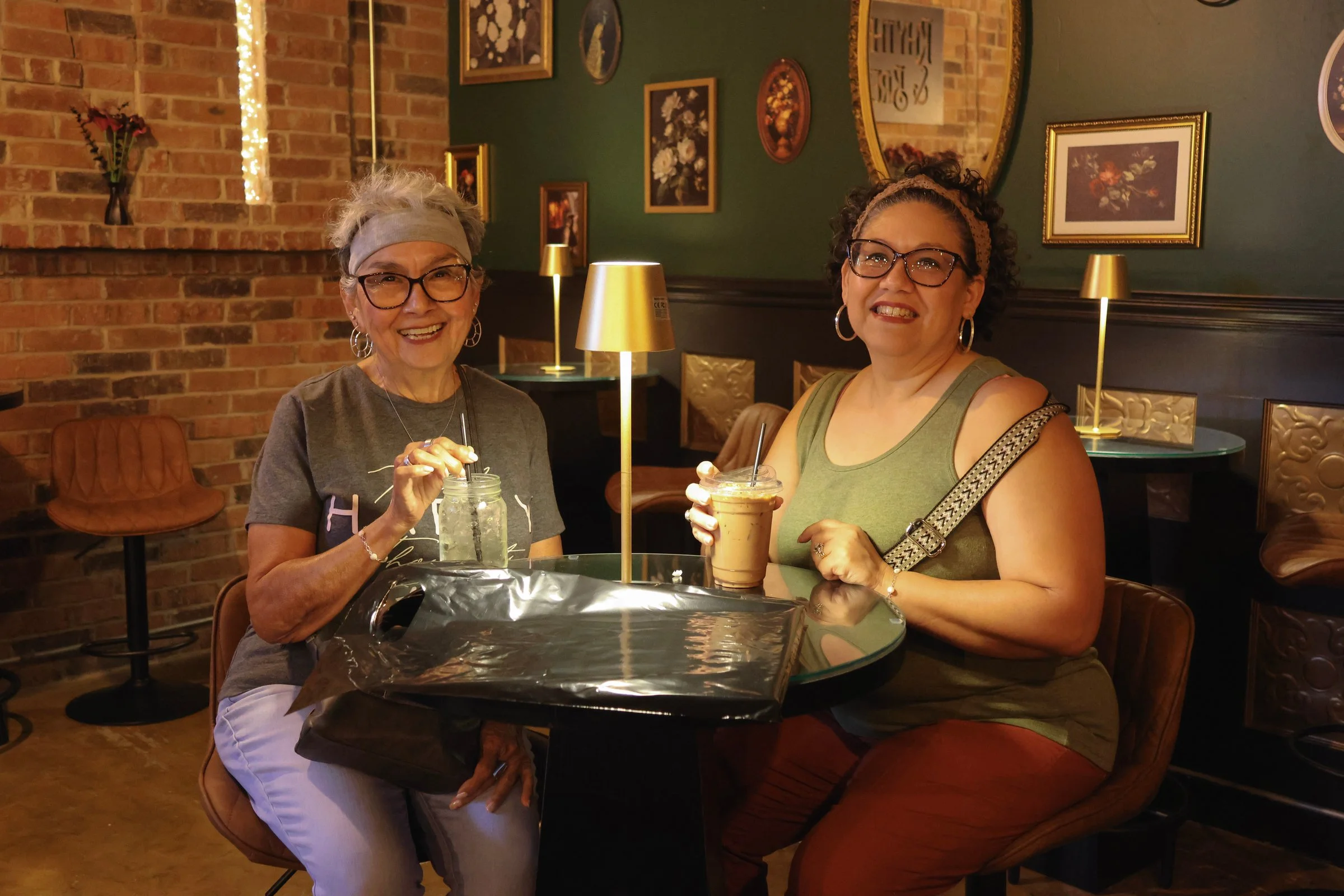Two friends sharing drinks at Rhythm & Brew on opening night